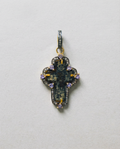 Close-up of authentic 17th–18th century sand-cast copper Old Believers Christian cross with historical patina and engravings, set in 24kt gold-plated sterling silver with diamond and tanzanite accents on a vintage paper. 