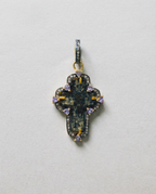 Close-up of authentic 17th–18th century sand-cast copper Old Believers Christian cross with historical patina and engravings, set in 24kt gold-plated sterling silver with diamond and tanzanite accents on a vintage paper. 