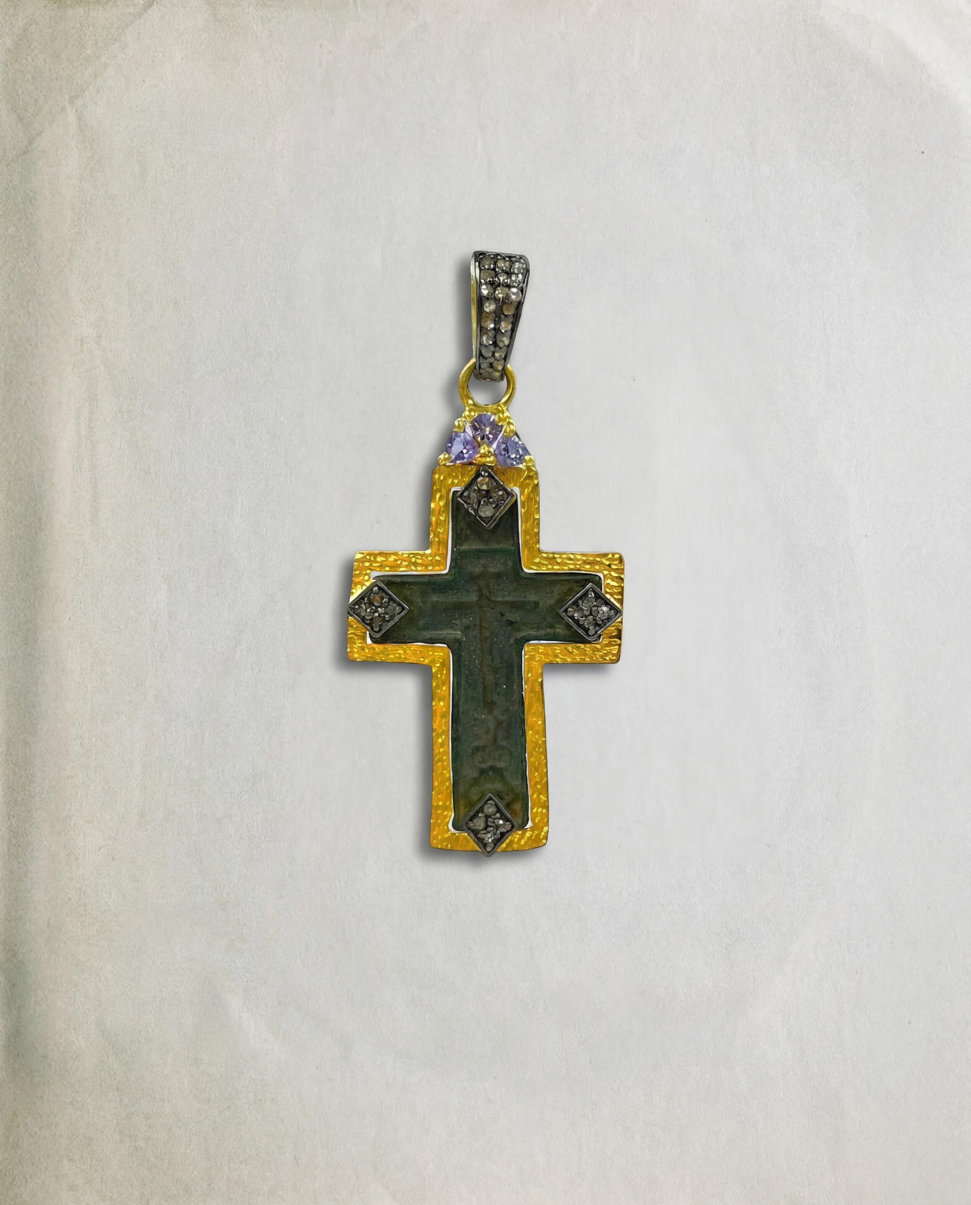  Late 17th–18th century Russian Orthodox baptismal cross in 24kt gold-plated silver frame with aged green patina, 0.39ct diamonds and violet tanzanite accents on vntage paper background.