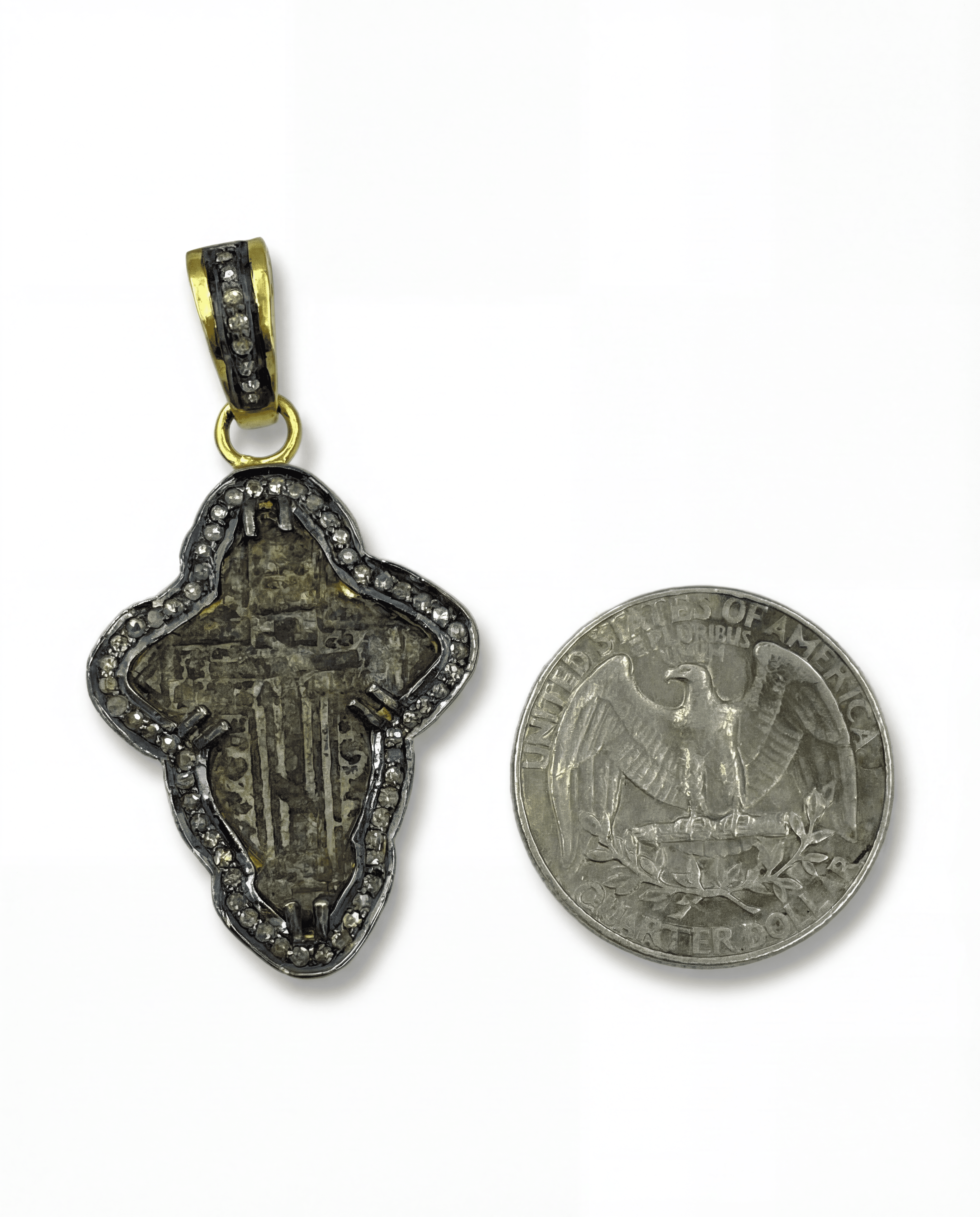 Diamond-set bail on late 17th–18th century Orthodox baptismal cross necklace in 24kt gold-plated sterling silver with 0.65ct natural diamonds next to a U.S. quarter coin on a white background