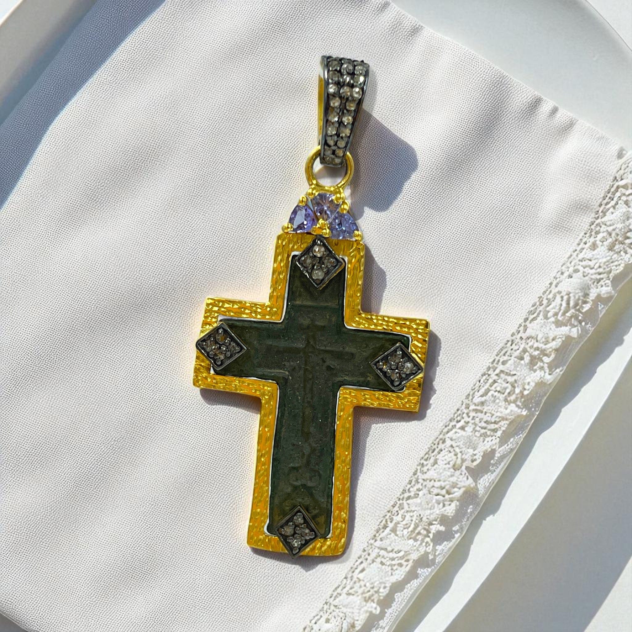 Close-up of authentic late 17th–18th century sand-cast copper Old Believers cross with aged green patina, set in 24kt gold-plated sterling silver with natural diamond accents
