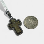 Diamond-set bail on 17th–18th century Old Believers Orthodox cross necklace in oxidized sterling silver with 0.73ct natural diamonds next to a U.S. quarter on a white background