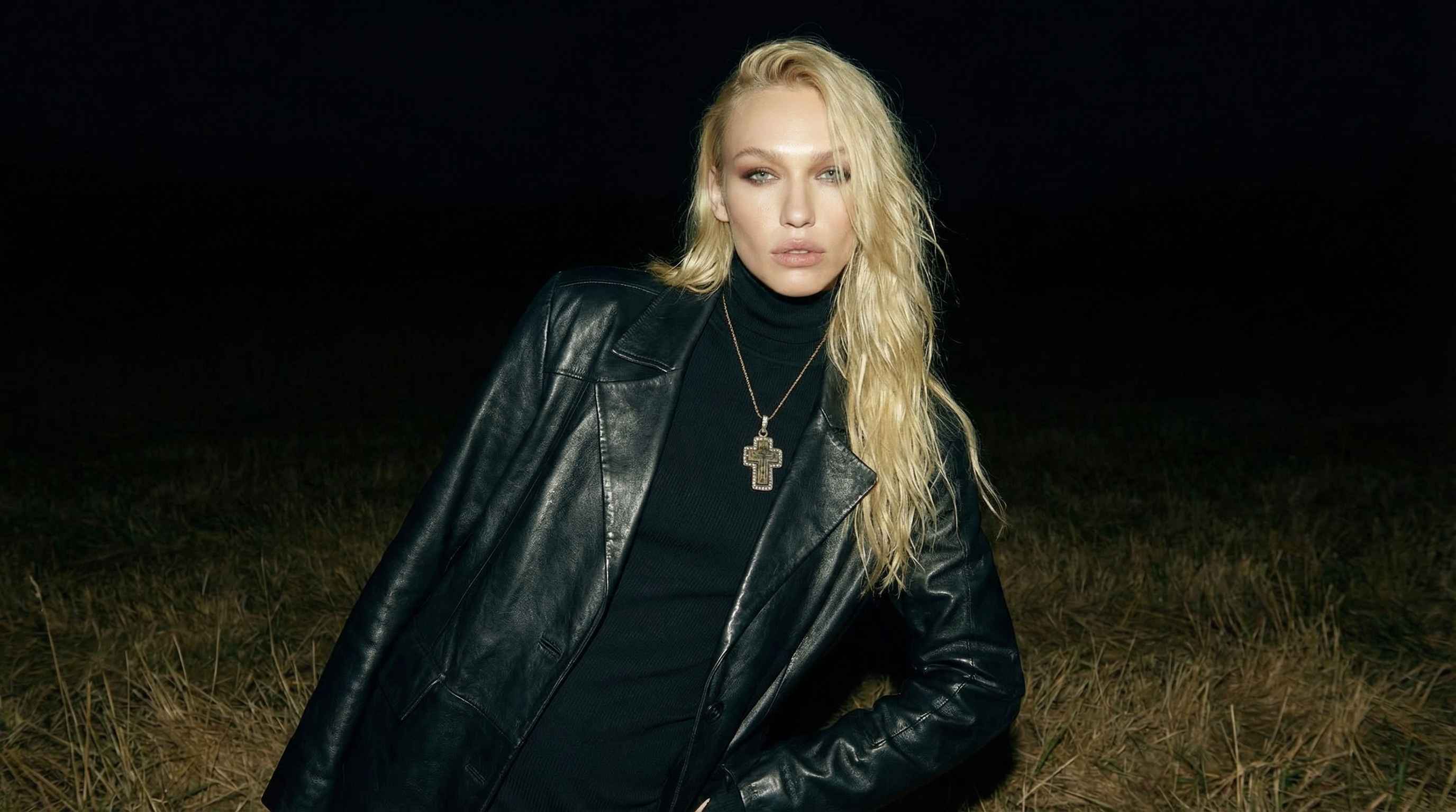 Woman wearing an antique Orthodox cross pendant at night, a one-of-a-kind historical relic reborn as heirloom jewelry.