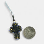 Jeweled bail with 1.04ct violet tanzanite on 17th–18th century Orthodox Old Believers cross necklace in 24kt gold-plated sterling silver with 0.6ct natural diamonds next to a quarter on a white background