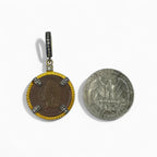 Diamond-set bail on 1903 Indian Head cent necklace in 24kt gold-plated sterling silver with 0.34ct natural diamonds and original copper patina next to a U.S. quarter dollar coin on a white background.