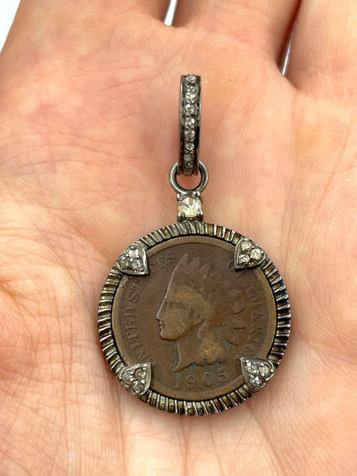 Close-up of authentic 1905 Indian Head Penny obverse with Lady Liberty in feathered headdress and original copper patina, set in sterling silver with natural diamond accents on a hand